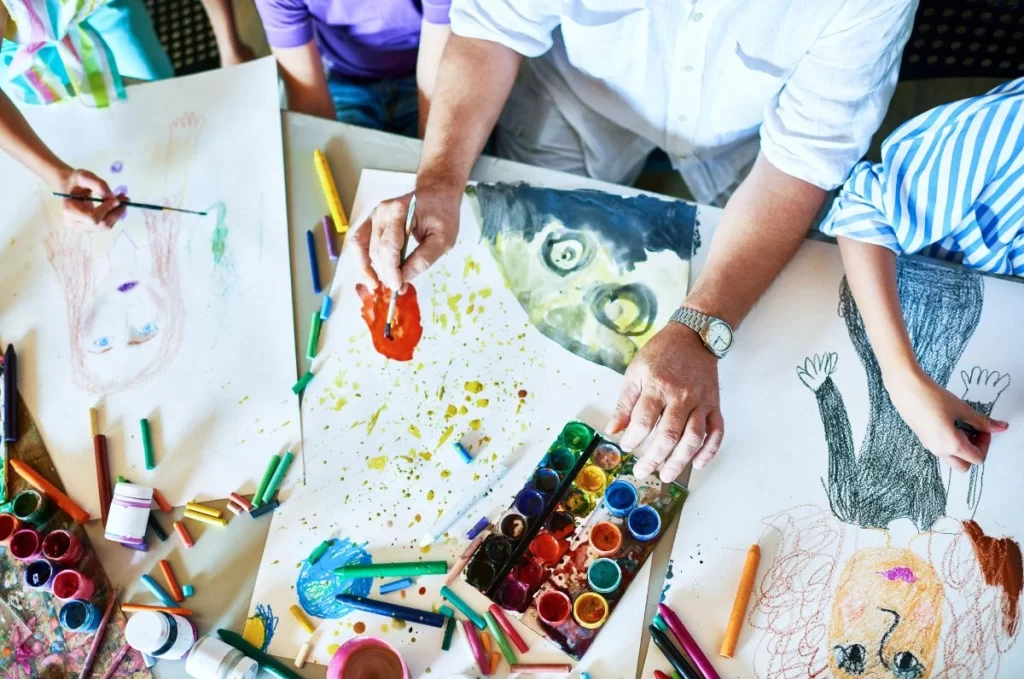 Several children drawing and painting 