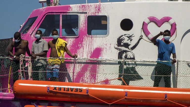 Banksy Clashes with Home Secretary James Cleverly Over Glastonbury Artwork and Migrant Rescue Efforts