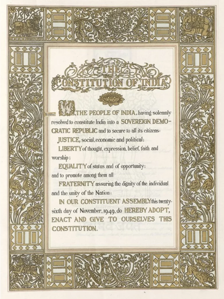 The preamble page of the original handwritten Indian Constitution, adorned with intricate artwork, floral motifs, and symbolic designs representing India's cultural heritage.