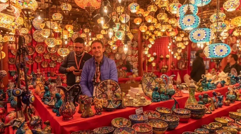 A shopkeeper selling traditional bowls, utensils, and other items 