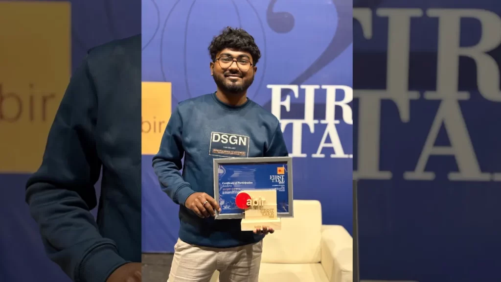 Avijit Dutta, a participant holding a certificate and trophy at the First Take event organized by Abir.