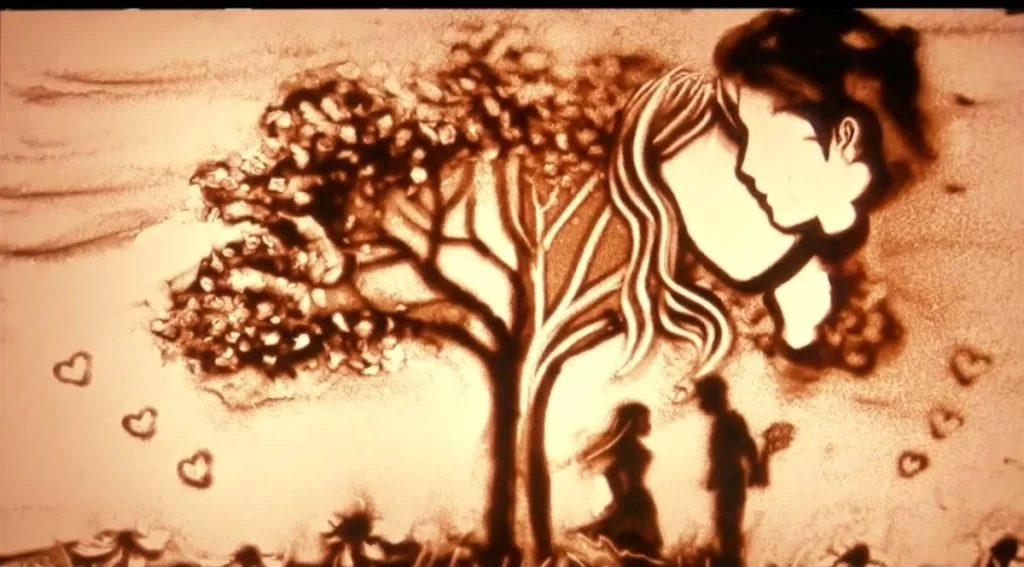 Sand Shadow art of a tree and a guy and a girl 