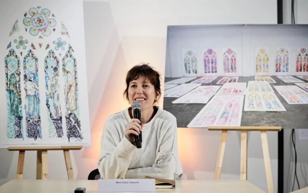 Claire Tabouret infront of her modern stained glass designs 