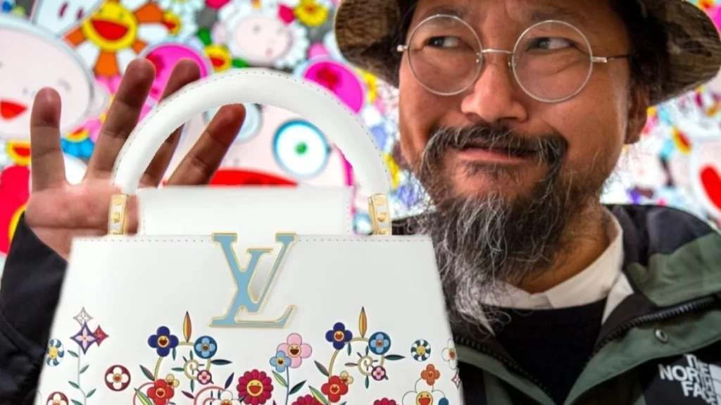 Takashi Murakami Standing next to an LV Bag